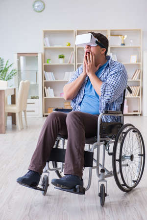 Disabled man studying with virtual reality glassesの写真素材