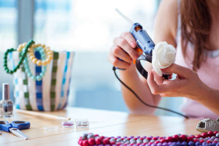 Woman making jewelry at homeの写真素材