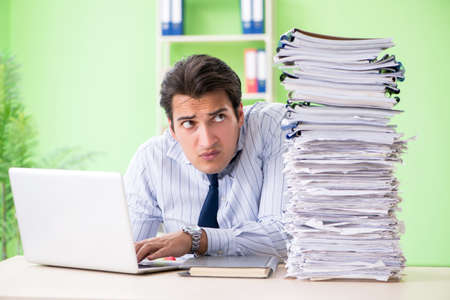 Businessman having problems with paperwork and workload
