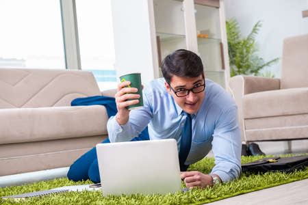 Businessman taking work home and working overtimeの写真素材