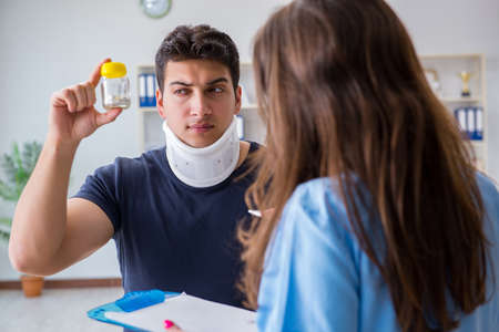 Man with neck injury visiting doctor for check-upの写真素材