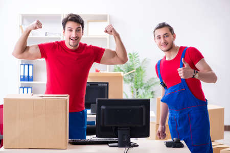 Two contractor employees moving personal belongingsの写真素材