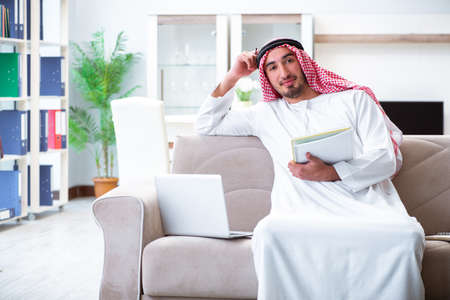 Arab man working at home on his workの写真素材