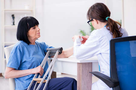 Doctor examining old mature woman after incident