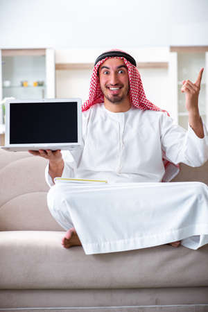 Arab man working at home on his workの写真素材