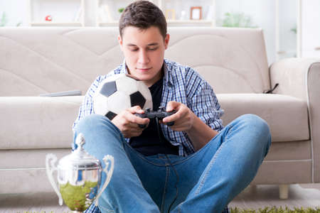 Young man playing computer games at home