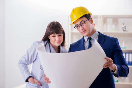 Doctor discussing new hospital plan with architect