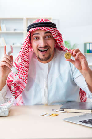 Arab man with bitcoin in cryptocurrency mining conceptの写真素材