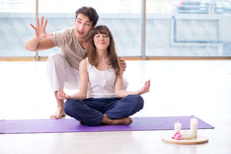 Personal coach helping during yoga sessionの写真素材