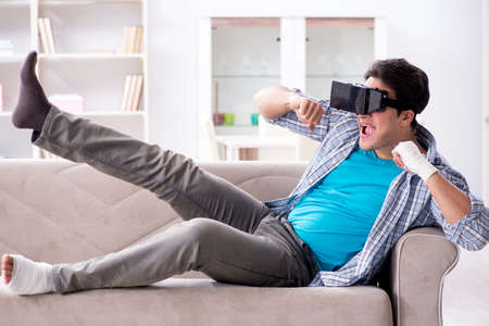 Man with hand injury wearing virtual reality glasses