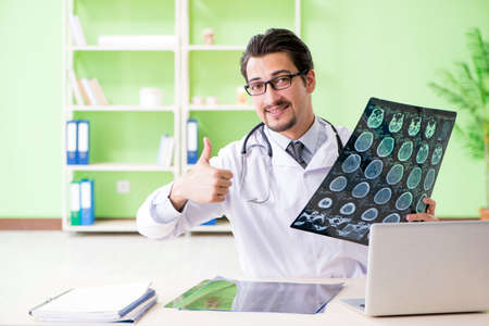 Doctor radiologist looking at x-ray scan in hospital