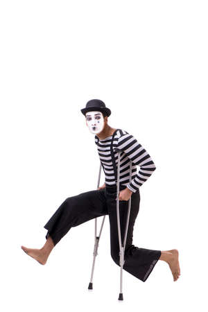 Mime with crutches isolated on white backgroundの写真素材