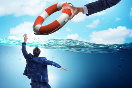 Businessman being saved from drowningの写真素材