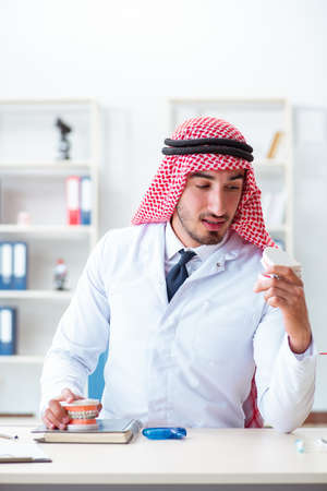 Arab dentist working on new teeth implantの写真素材