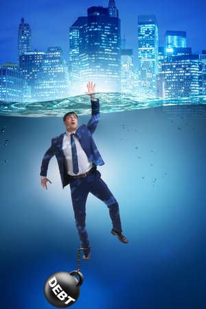 Businessman drowning in concept of high debtの写真素材