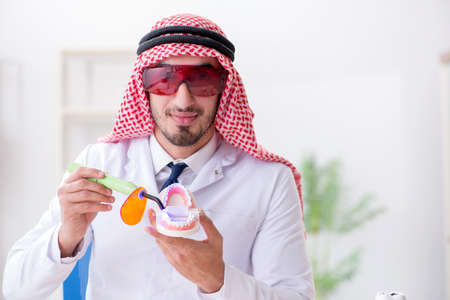 Arab dentist working on new teeth implantの写真素材