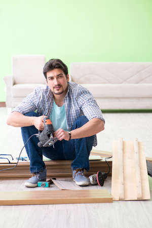 Man laying flooring at homeの写真素材