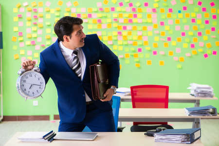 Businessman with many conflicting priorities in time managementの写真素材