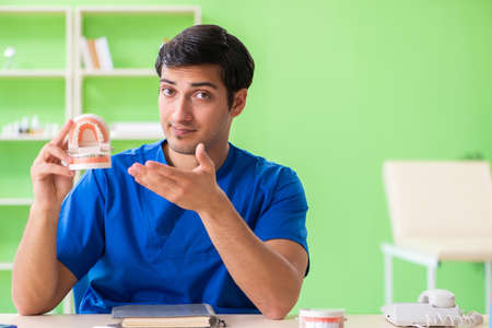 Man dentist working on new teeth implant