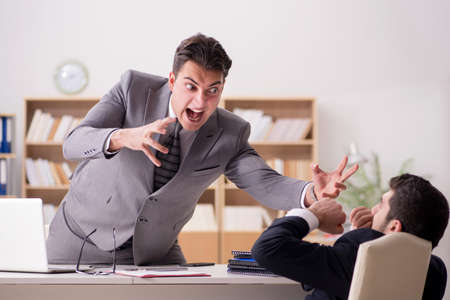 Angry boss shouting at his employeeの写真素材