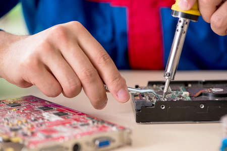 Computer engineer repairing broken desktop