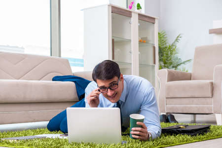 Businessman taking work home and working overtimeの写真素材