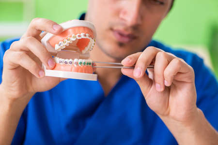 Man dentist working on new teeth implantの写真素材