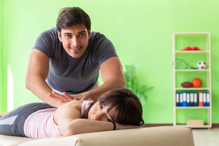 Young doctor chiropractor massaging patient