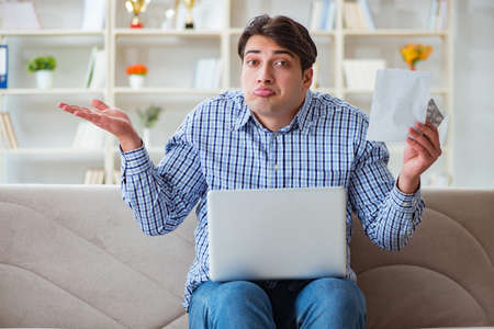 Young man sitting on the sofa with pills and prescription