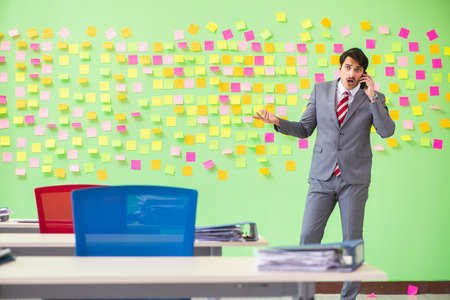 Businessman with many conflicting prioritiesの写真素材