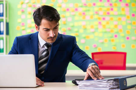 Businessman with many conflicting prioritiesの写真素材