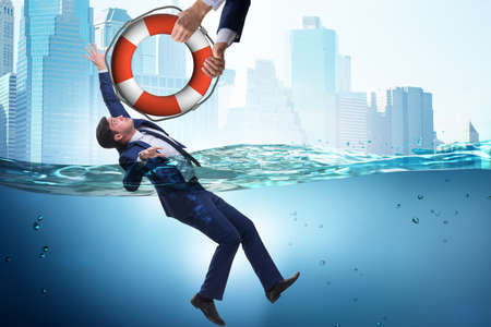 Businessman being saved from drowningの写真素材