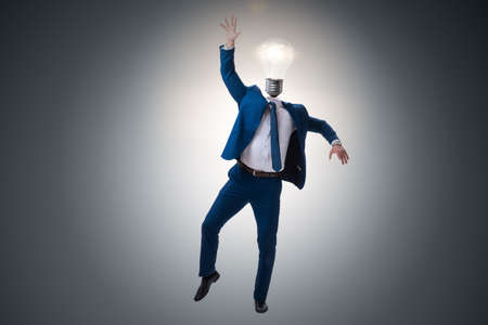 Businessman in bright idea concept with lightbulb head