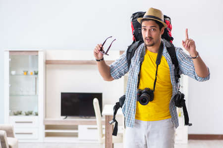 Backpacker packing for his tripの写真素材