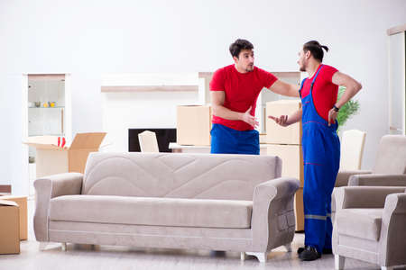 Two contractor employees moving personal belongingsの写真素材