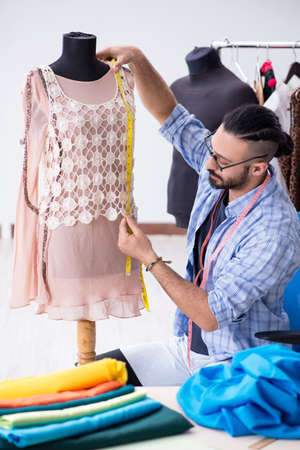 Male tailor working in the workshop on new designsの写真素材