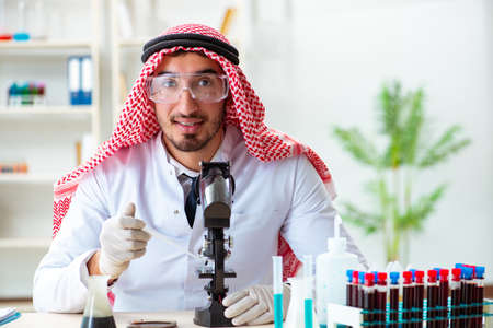 Arab chemist working in the lab officeの写真素材