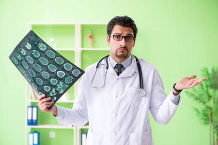 Doctor radiologist looking at x-ray scan in hospital