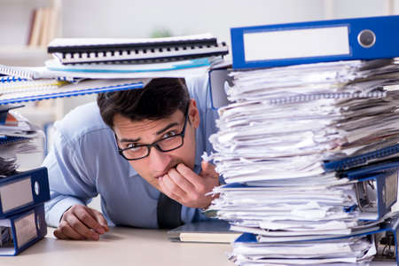 Extremely busy businessman working in office