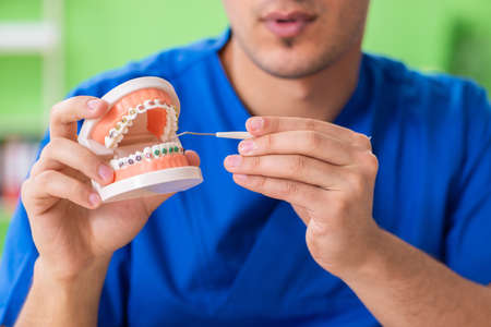 Man dentist working on new teeth implantの写真素材