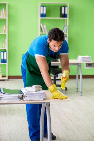 Male handsome professional cleaner working in the officeの写真素材