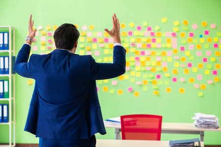 Businessman with many conflicting prioritiesの写真素材