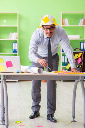 Male engineer working on new project with many conflicting priorの写真素材