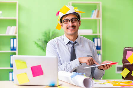 Male engineer working on new project with many conflicting priorの写真素材