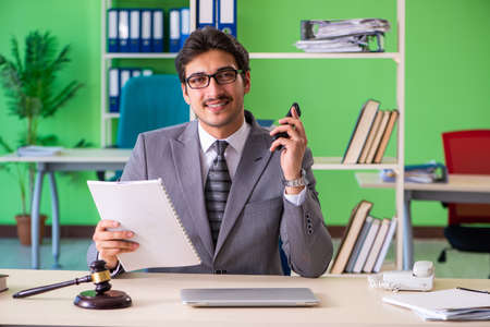 Young handsome lawyer working in the officeの写真素材