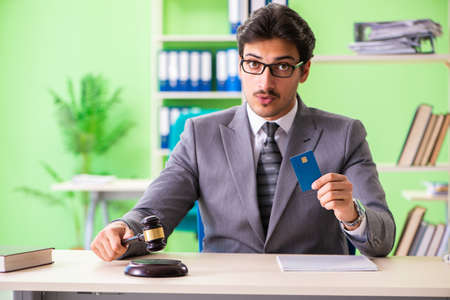 Young handsome lawyer working in the office