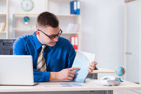 Young employee preparing for vacation tripの写真素材