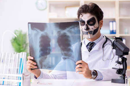 Scary monster doctor working in labの写真素材