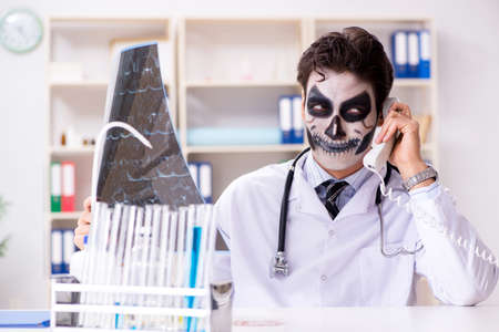 Scary monster doctor working in labの写真素材