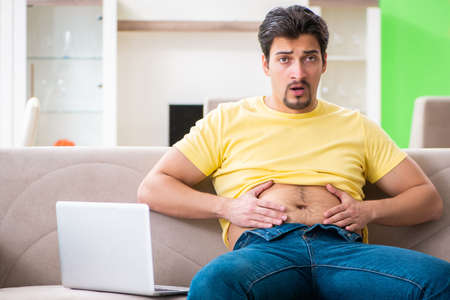 Young fat man in dieting conceptの写真素材
